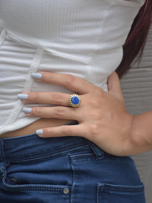 Preet Ring showcasing a striking blue meena center stone surrounded by a delicate golden flower motif.