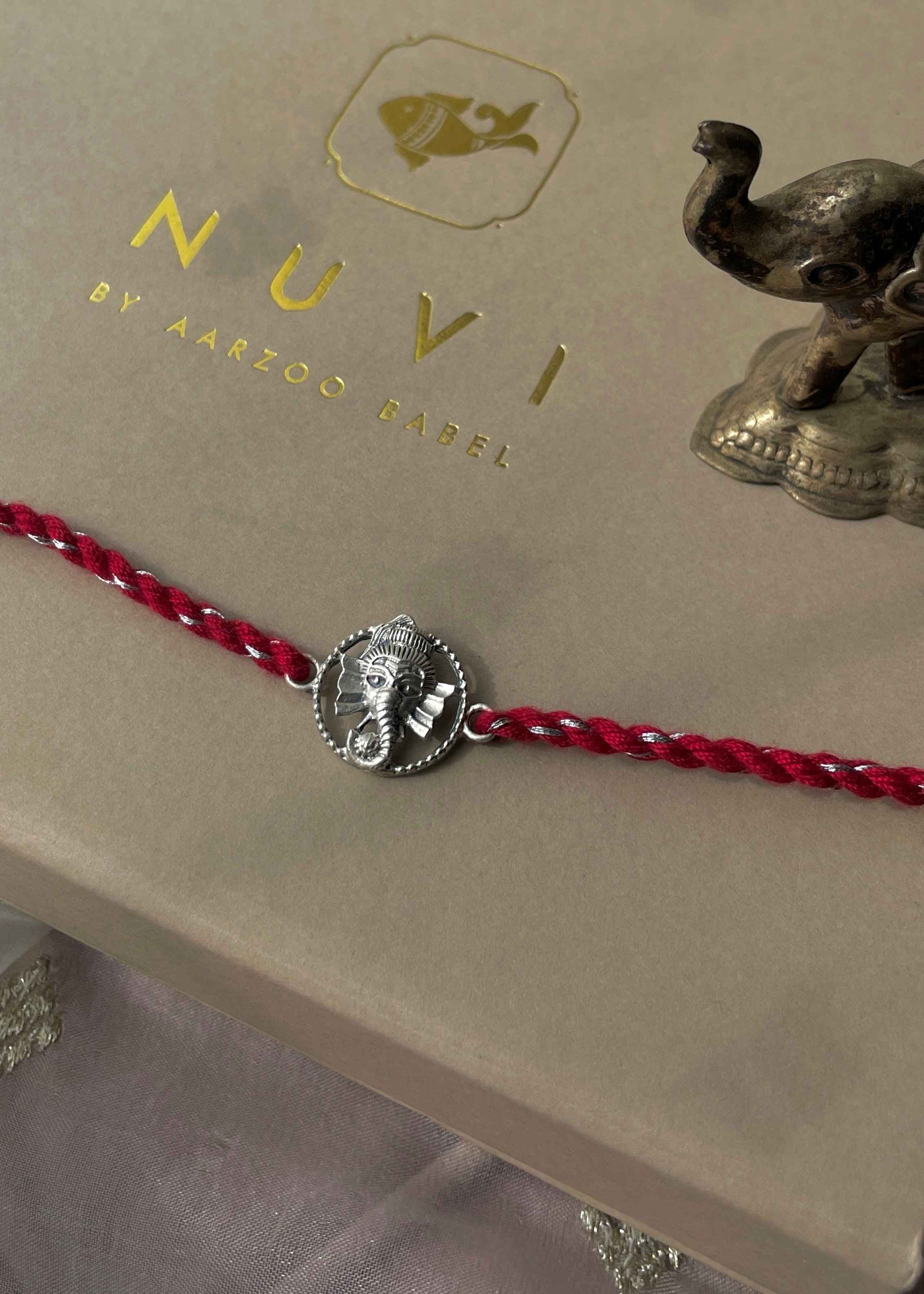 Beautiful 92.5 sterling silver Rakhi crafted with sterling silver and cotton thread.