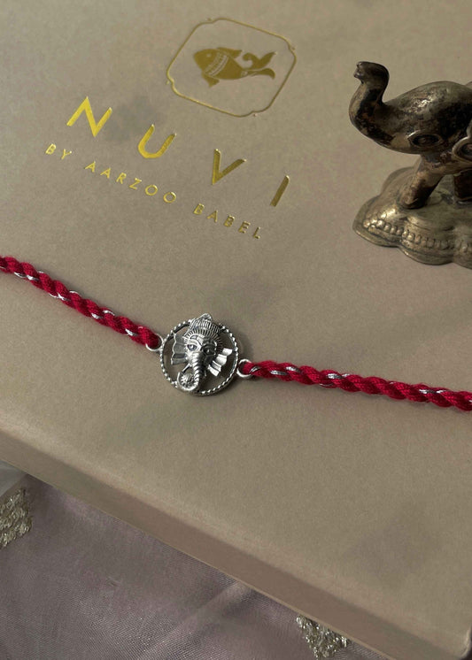 Beautiful 92.5 sterling silver Rakhi crafted with sterling silver and cotton thread.