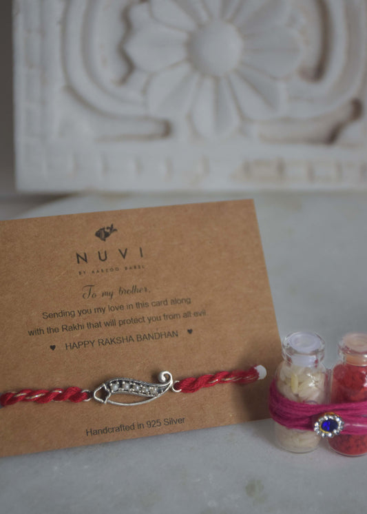 92.5 sterling silver Rakhi adorned with real freshwater pearls and cotton thread.