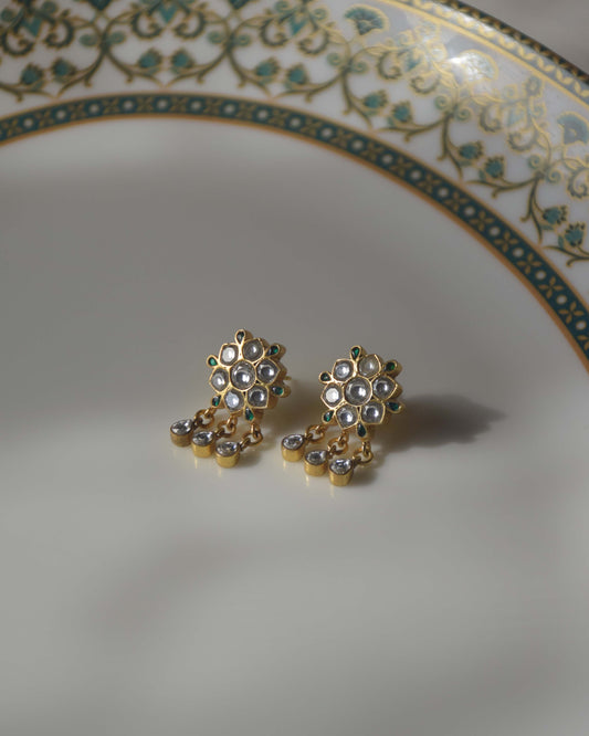 crafted in 925 silver, showcase an enchanting flower motif adorned with Jadau Stones and delicate hanging drops.