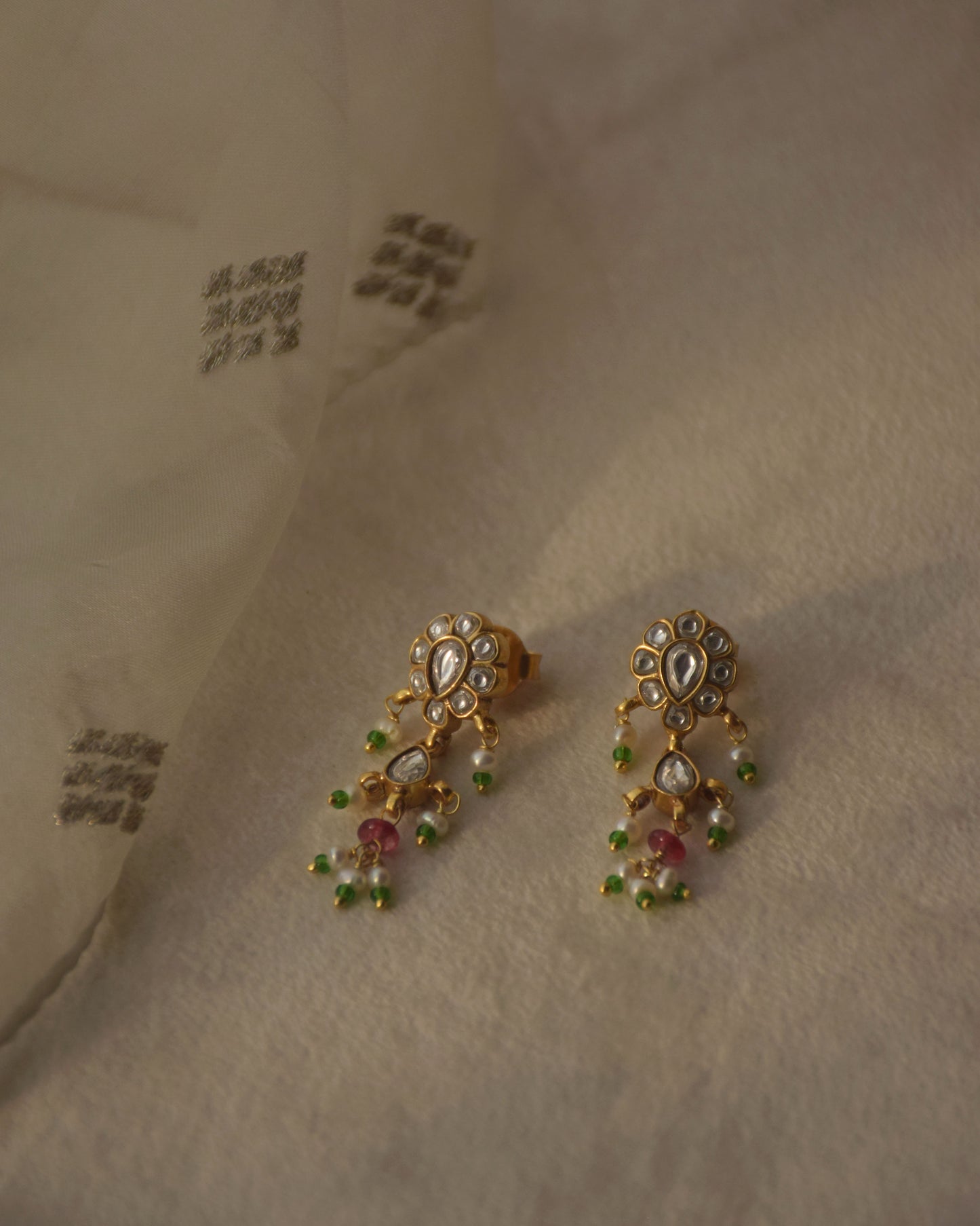 92.5 gold plated kundan earrings with jadau stone work and pearl drops.
