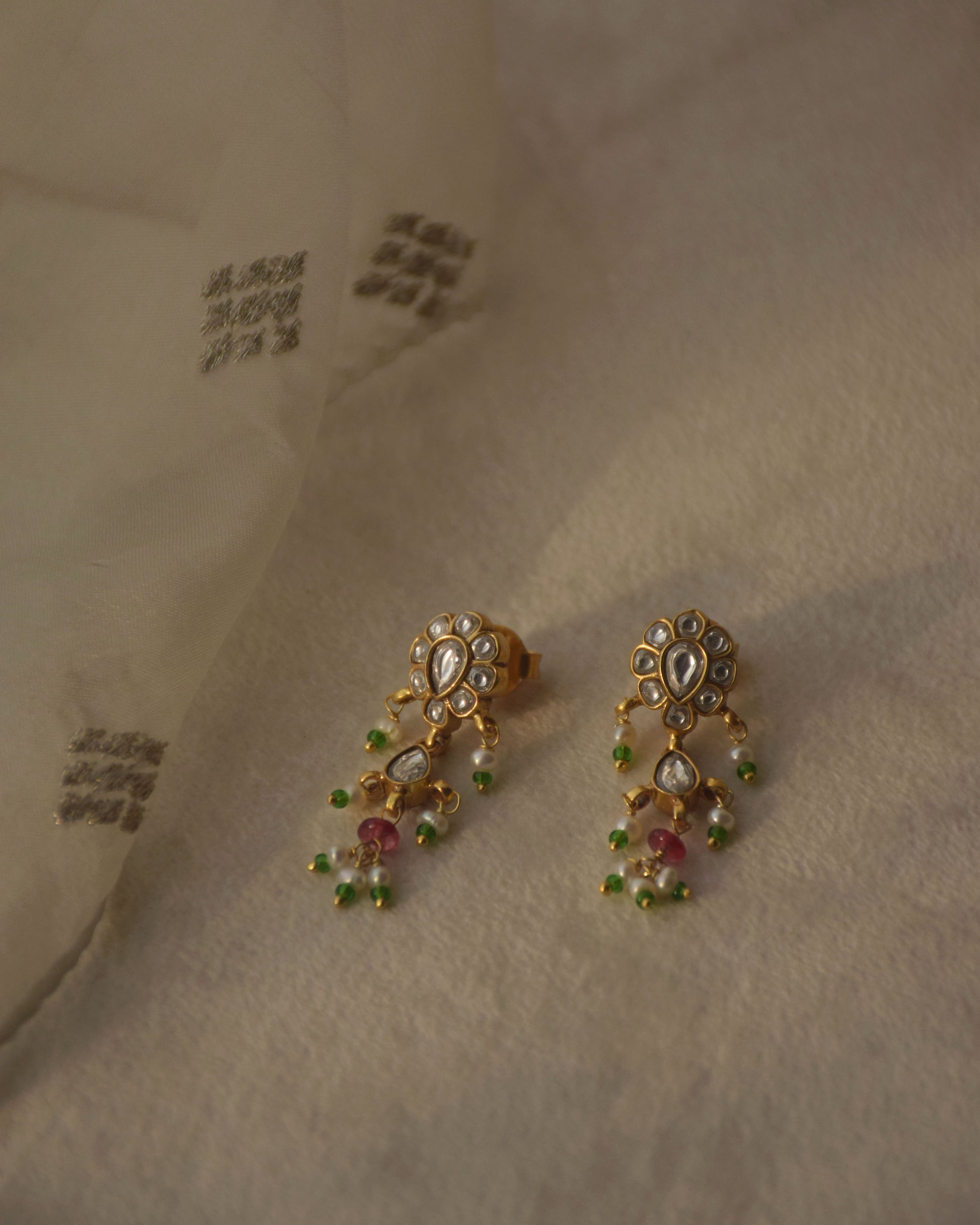 92.5 gold plated kundan earrings with jadau stone work and pearl drops.