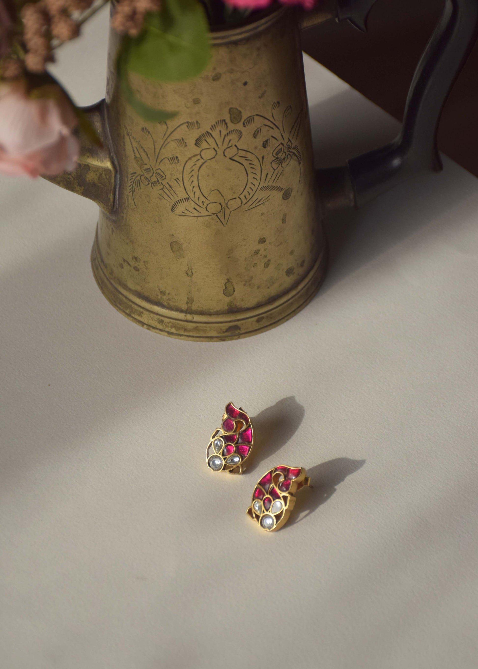 Nuvi Matsya Earrings featuring an enchanting fish motif adorned with intricate Jadau stones, crafted in 925 silver.