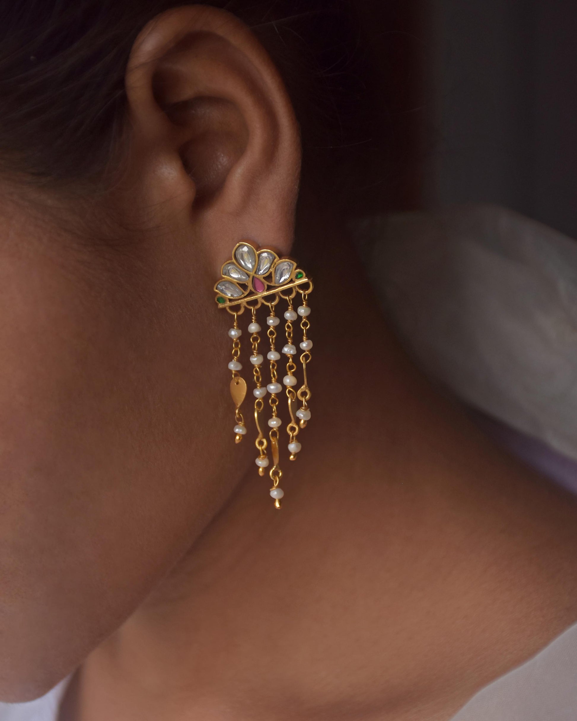 925 sterling silver gold-plated earrings featuring a floral Jadau motif with subtle color, cascading freshwater pearls, and a delicate golden leaf, creating a light, feminine, and timeless design