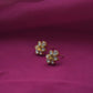 All-white Jadau floral stud earrings crafted from gold-polished 925 silver.