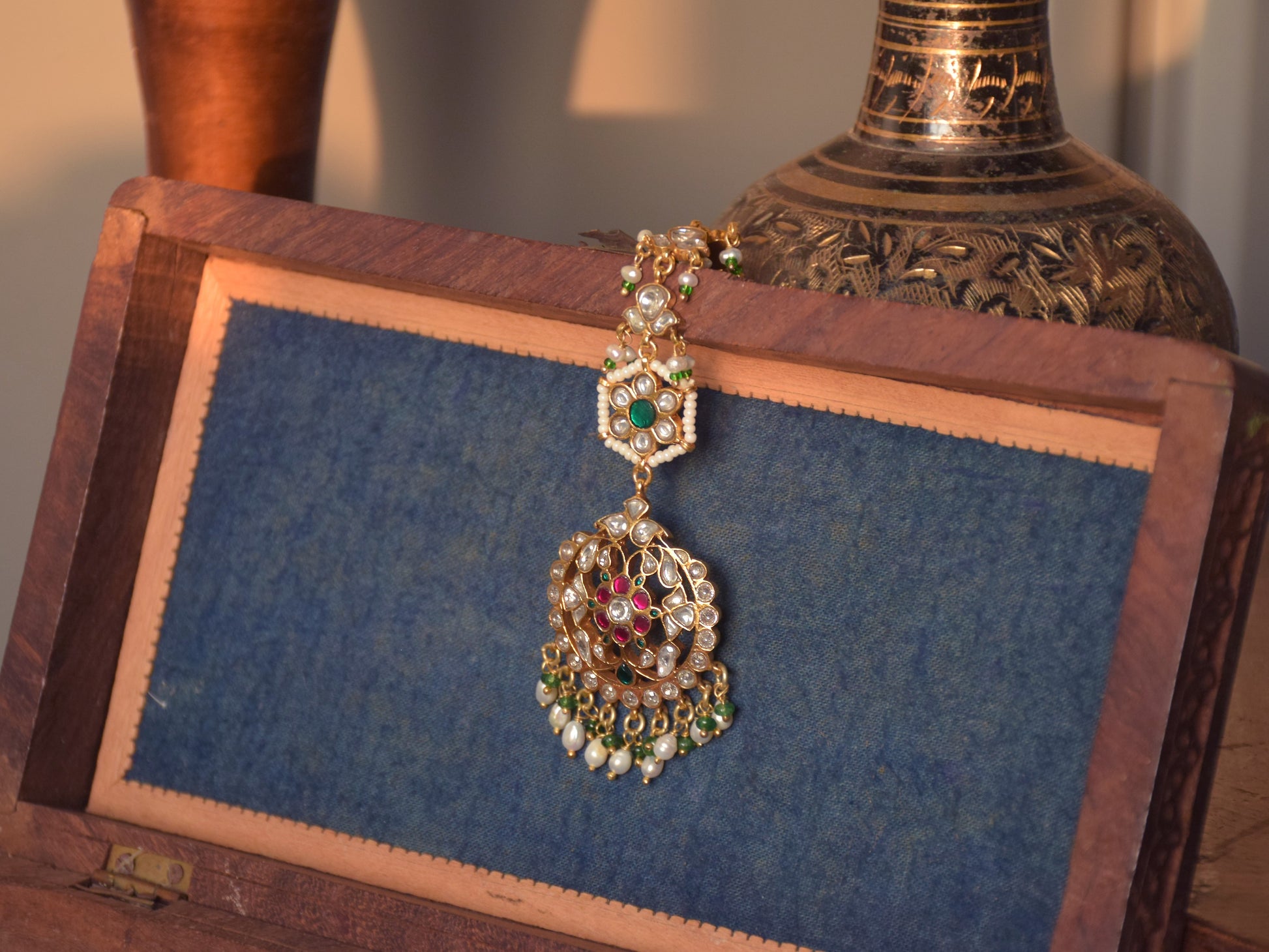 Classic Jadau maangtika handcrafted in 925 silver, featuring floral motifs and elegant pearl bead hangings for ethnic wear.Explore premium 925 silver jewellery in Ahmedabad