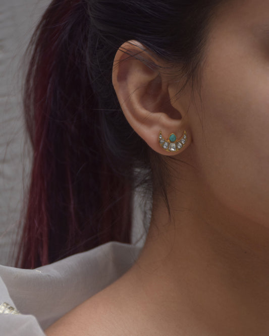 Chand Firoza earstuds crafted in 925 silver with 22-karat gold polish, featuring a minimalistic design with Jadau chand adorned with pristine white Jadau stones and a captivating Firoza stone at the center.