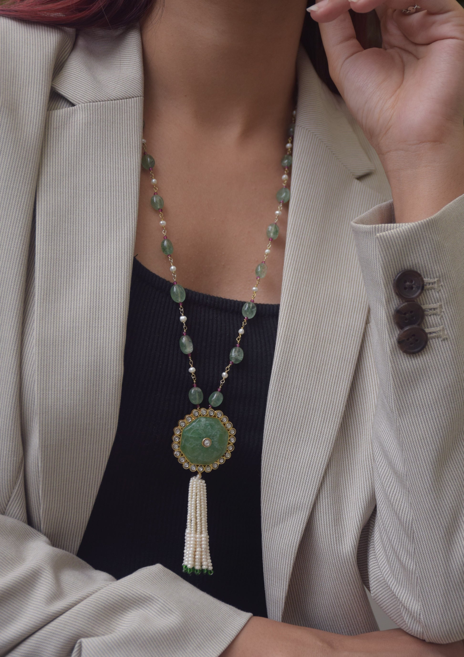 Chandani Tassel Necklace featuring a carved Aventurine centerpiece bordered with shimmering Jadau stones, strung on an Aventurine tumble bead chain, finished with a delicate seed pearl tasse.