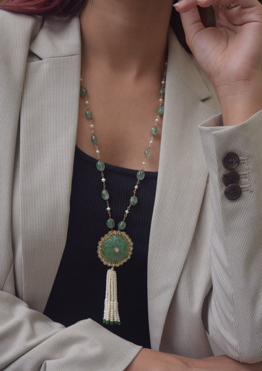 Chandani Tassel Necklace featuring a carved Aventurine centerpiece bordered with shimmering Jadau stones, strung on an Aventurine tumble bead chain, finished with a delicate seed pearl tasse.