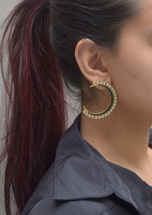  Contemporary chand-shaped earrings handcrafted in 92.5 sterling silver, featuring rich black meena detailing and elegant Jadau petal stones.