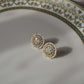 Classic 925 silver ear studs featuring intricate white Jadau stones arranged in a round floral design, accented with a delicate border of seed pearls