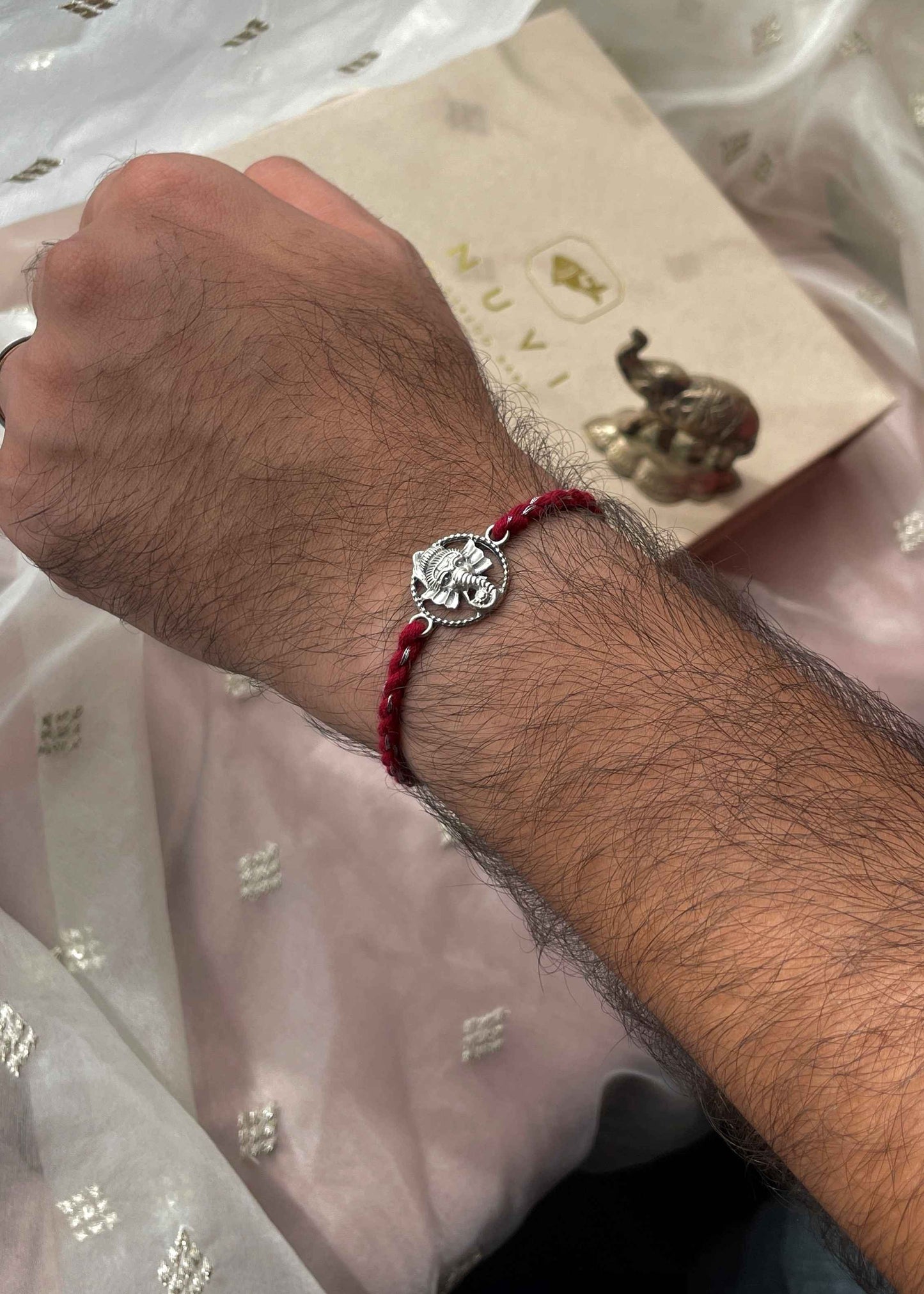 Handcrafted 925 sterling silver rakhi with elegant Ganesha charm detailing