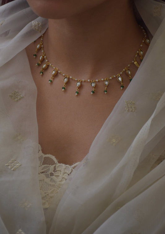 Dori Necklace handcrafted in 925 silver with gold polish, featuring petal-shaped jadau units and lustrous freshwater pearls, including a single pearl drop.