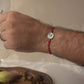 Ek Onkar rakhi in 925 sterling silver with red cotton thread. Comes with complimentary Kumkum & Chawal.