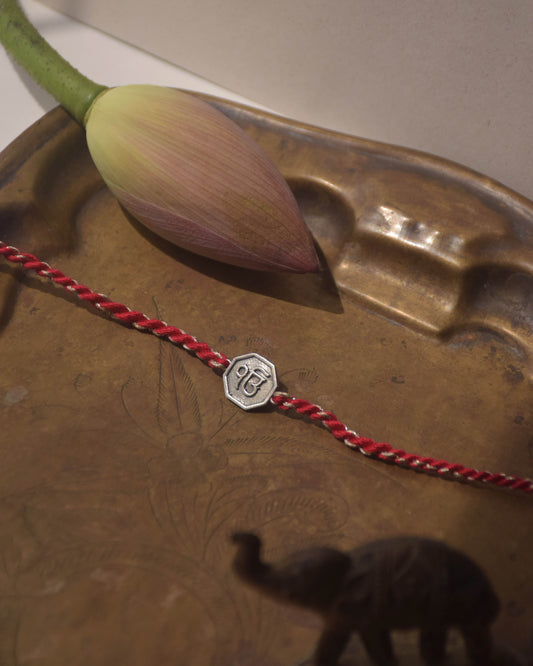 Ek Onkar Sterling Silver Rakhi with cotton read Thread. It comes with a set of Roli and Chawal