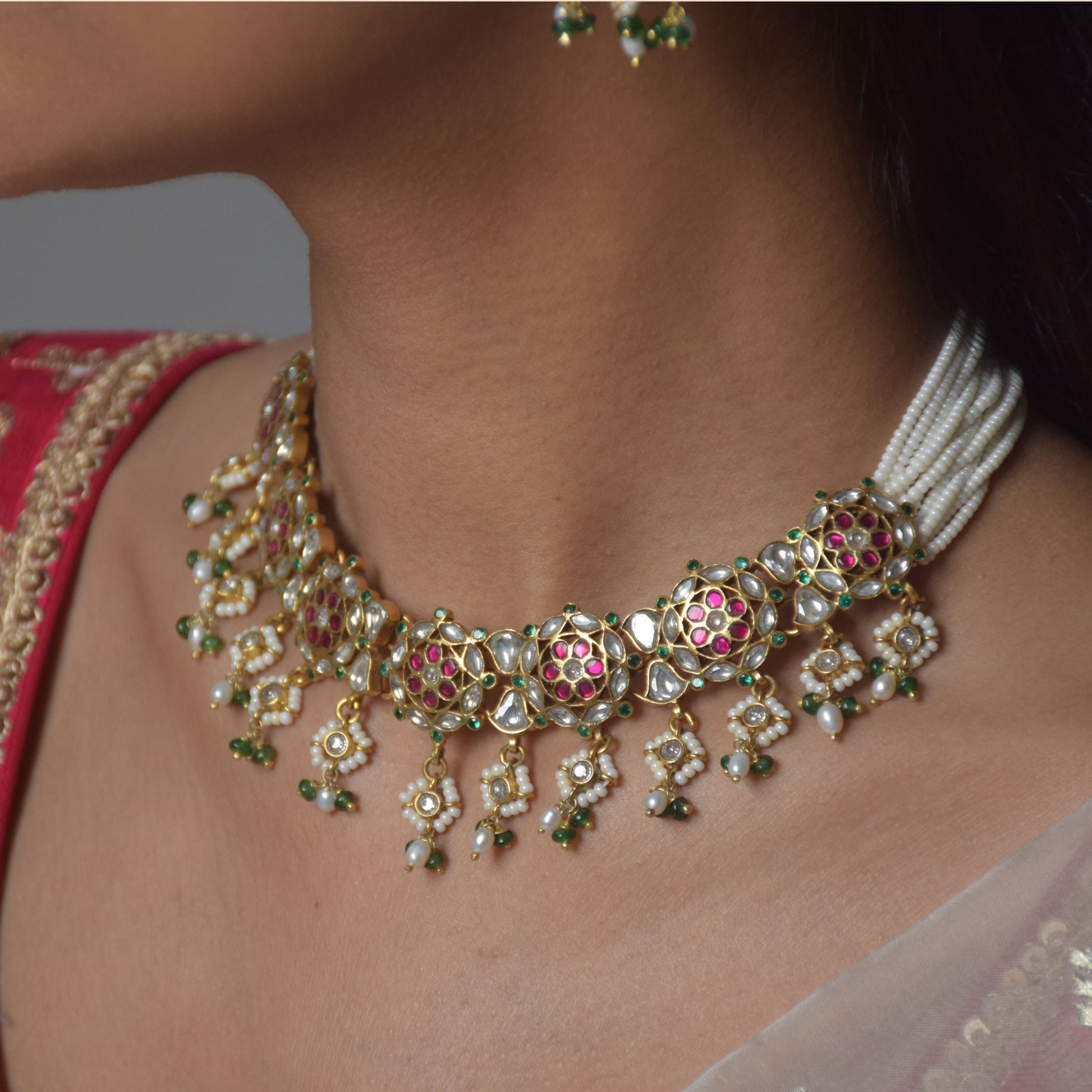 Handmade Ranisa Jadau choker in 925 silver with gold plating, combining traditional Indian artistry, colorful stones, and delicate pearl detailing.