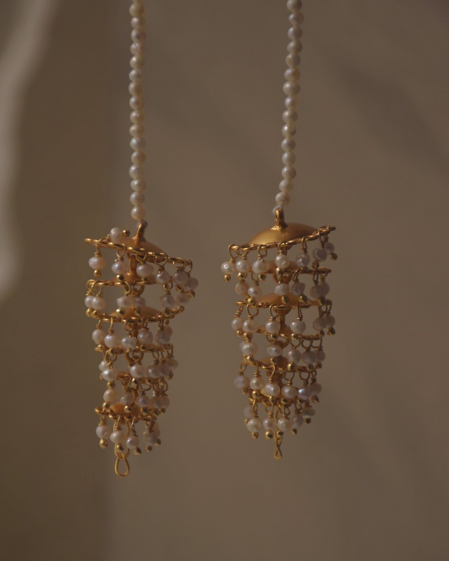 Handcrafted silver ear chain jewelry with intricate jhumki accents, festive statement piece by NUVI JEWELS