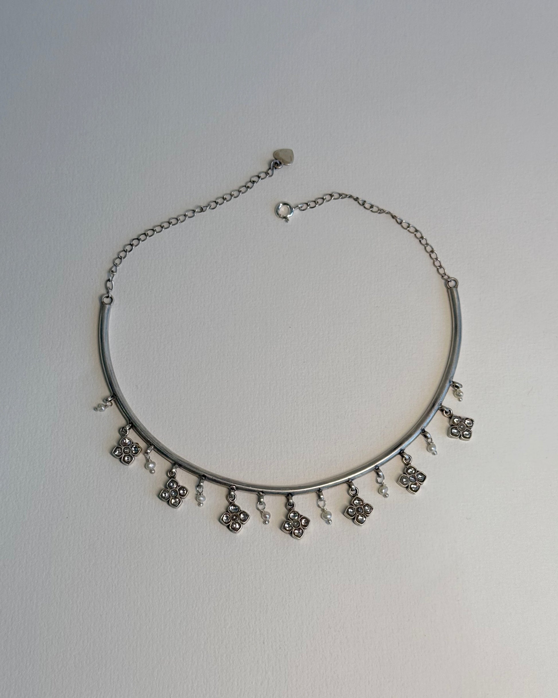 Nuvi Jewels Madhura Hasli in sterling silver gold plated featuring delicate flowers and dangling pearls