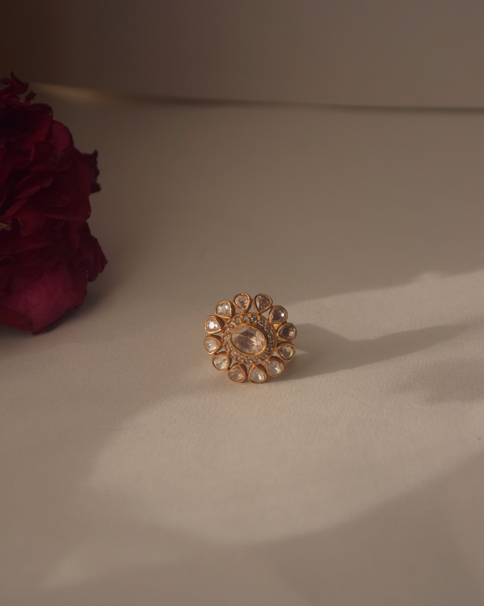 Fine craftsmanship Taarika ring featuring 925 sterling silver base with gold polish and intricate floral polki stone arrangement.