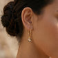 Elegant silver polki hoop earrings with black meena work border, perfect for contemporary styling with white shirts.