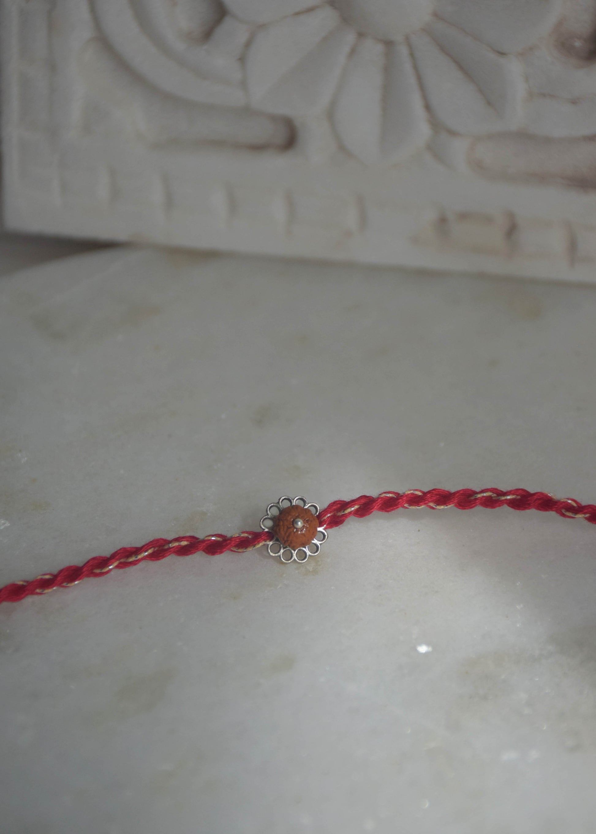 Elegant handcrafted Rudraksh rakhi in sterling silver designed for Raksha Bandhan gifting
