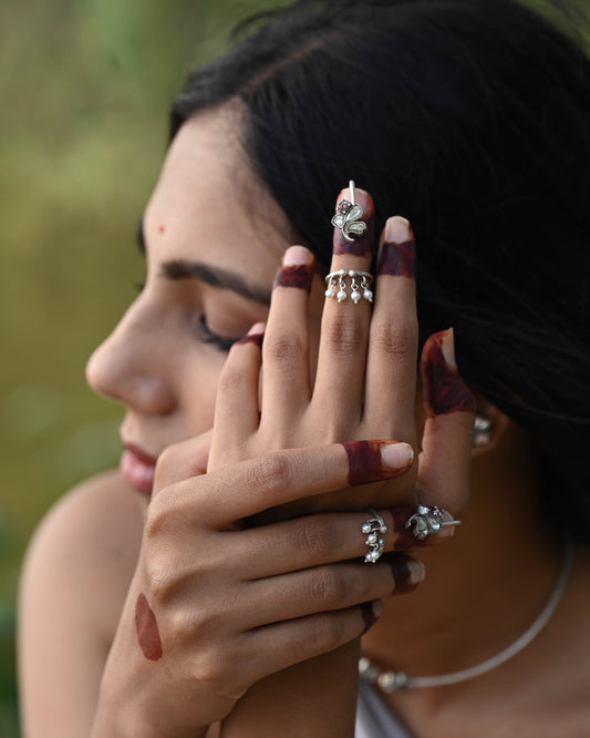 
Adjustable floral nail ring featuring radiant Jadau stones and delicate freshwater pearls, designed to elegantly adorn fingertips with a bold yet sophisticated statement Nuvi Jewels