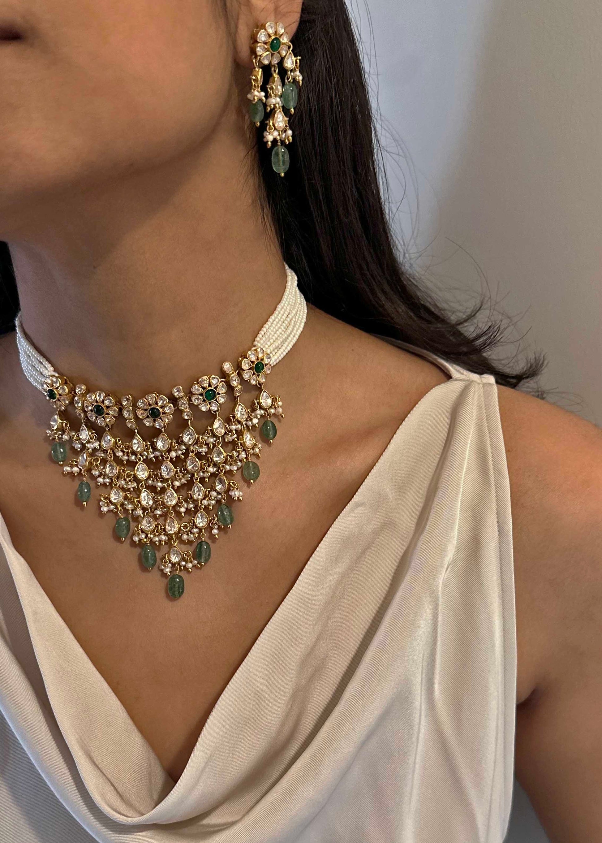 Gold-plated 925 sterling silver statement Polki choker with floral moissanite Polki units, pearl and Belur Polki accents, and green aventurine bead drops.