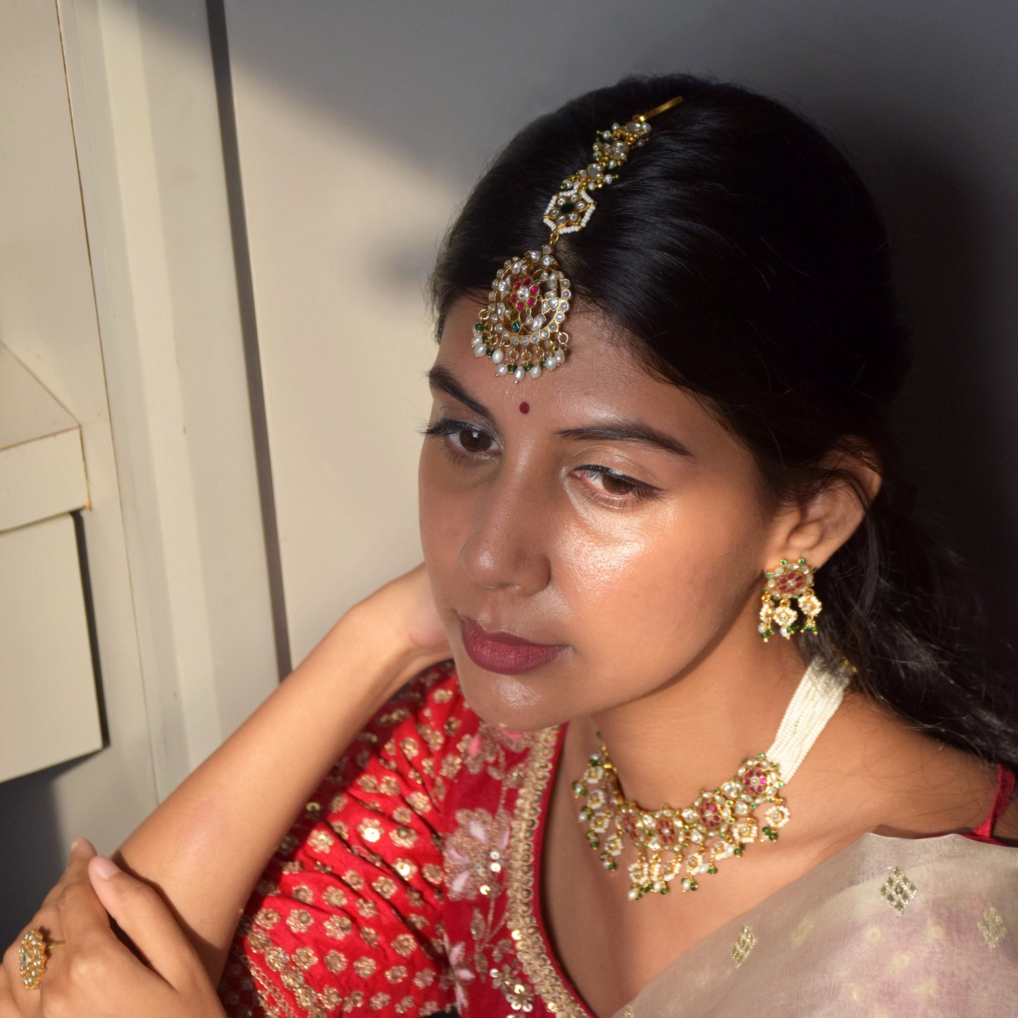 Handcrafted Hansa Maangtika by Nuvi Jewels in sterling silver, featuring multicolor Jadau stones and cascading pearl detailing for bridal styling.  925 pure silver statement jewelry handmade in Ahmedabad
