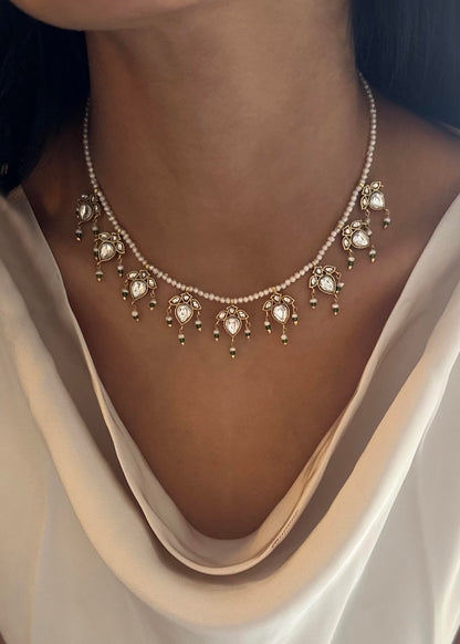 Maaeri necklace crafted in gold-plated 925 silver with a freshwater pearl string and a handcrafted leaf motif in Jadau glass stone work.