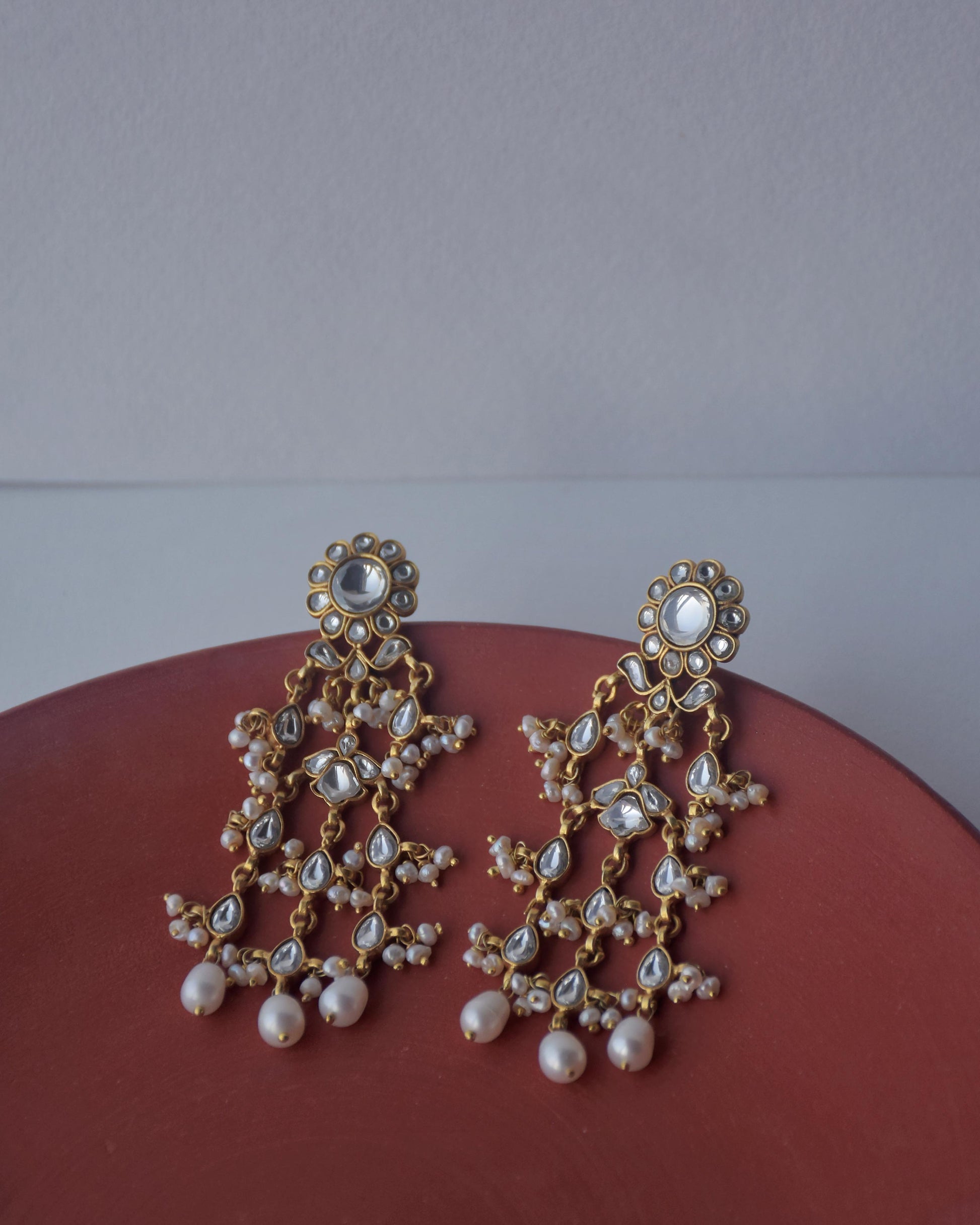 Handcrafted Jadau earrings perfect for weddings, featuring stones and pearls
