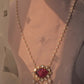Handcrafted gold-plated silver pendant featuring a carved pink glass centerpiece, surrounded by Polki stones, paired with a freshwater pearl chain.