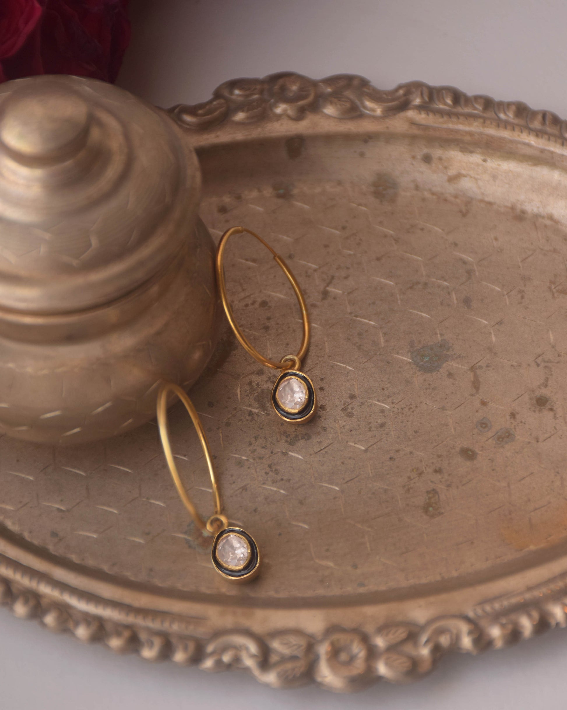 Handcrafted 925 silver Aarohi hoop earrings featuring a glowing polki drop outlined with black enamel meena work contrast.