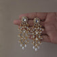 Intricate Jadau earrings with traditional stone work and pearl drops