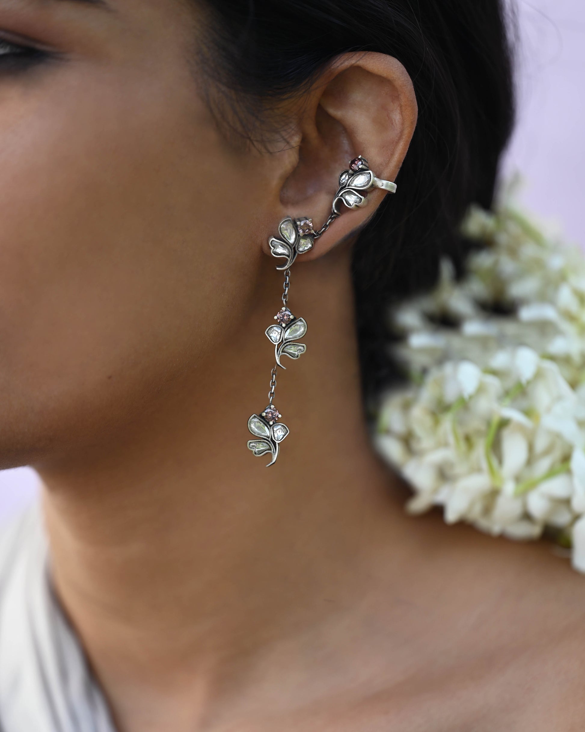 “Nuvi Jewels designer Madhura Earrings in 92.5 silver with four jadau-studded flowers connected by delicate chains