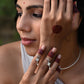 Nuvi Jewels Rasa Mid Ring in 92.5 silver featuring adjustable jadau motif and dangling freshwater pearl