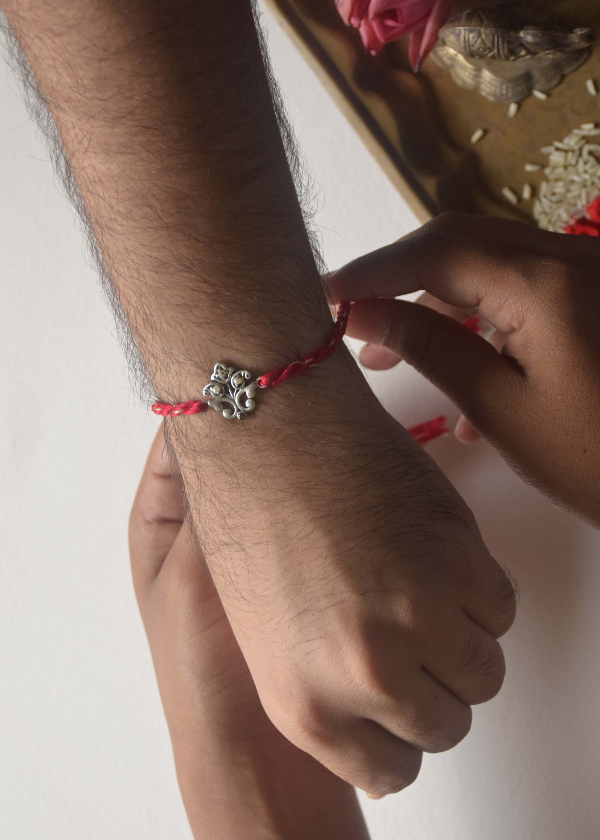 Premium 925 sterling silver Pearl Motif rakhi with delicate handcrafted pearl inspired detailing