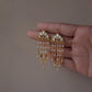 Statement Jadau earrings with floral motifs, freshwater pearls, and delicate gold details