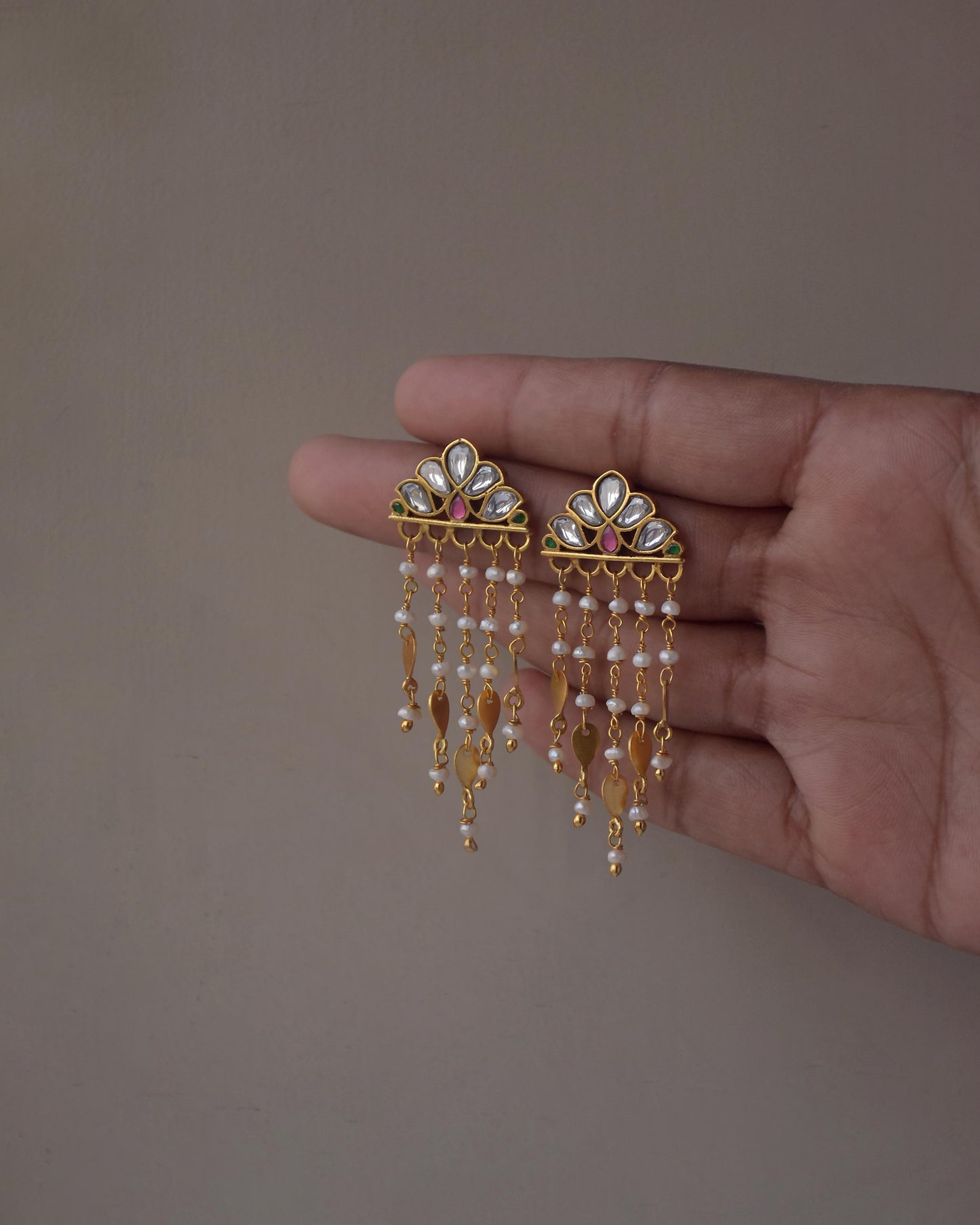 Statement Jadau earrings with floral motifs, freshwater pearls, and delicate gold details
