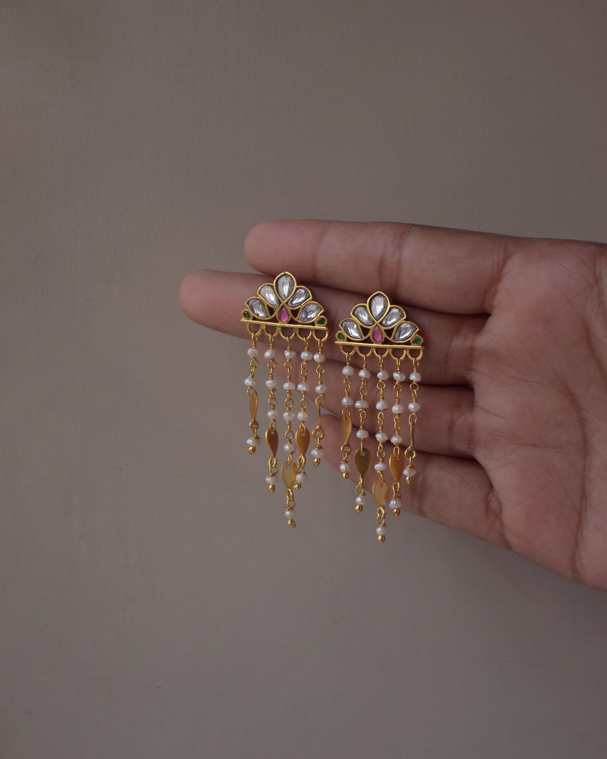 Statement Jadau earrings with floral motifs, freshwater pearls, and delicate gold details
