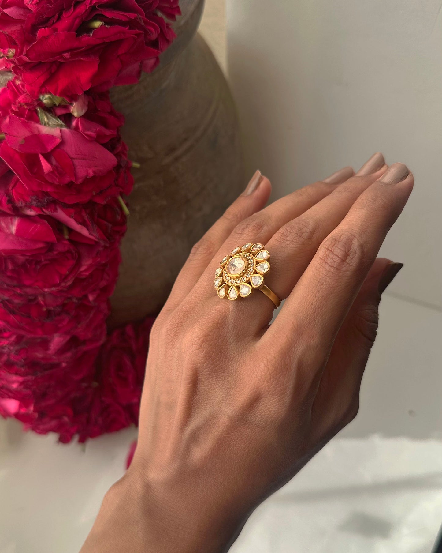 Handcrafted Taarika silver ring with bold floral silhouette and uncut style polki stones arranged in a sparkling cluster.