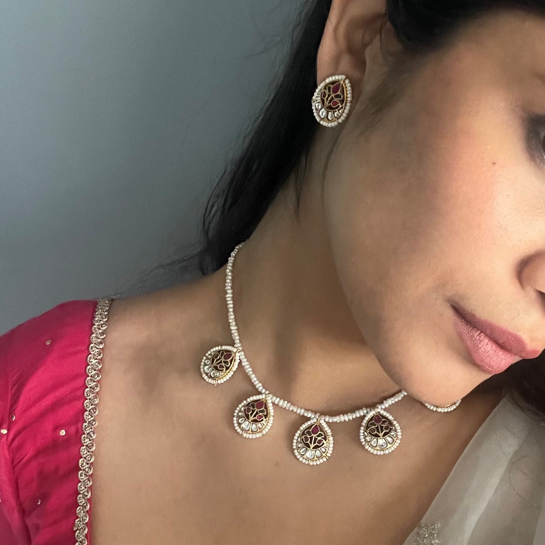 Pankhudi Necklace handcrafted in 925 silver with gold polish, featuring five jadau work petals adorned with pearl accents, hanging from lustrous freshwater pearls.