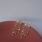 Luxury Jadau earrings with hand-set stones, freshwater pearls, and golden leaf detailing