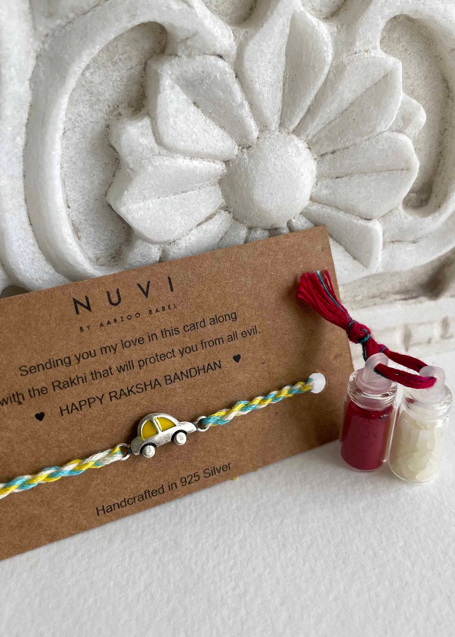 Kids’ Rakhi crafted from 925 silver, featuring a playful little car charm with bright yellow enamel detailing.