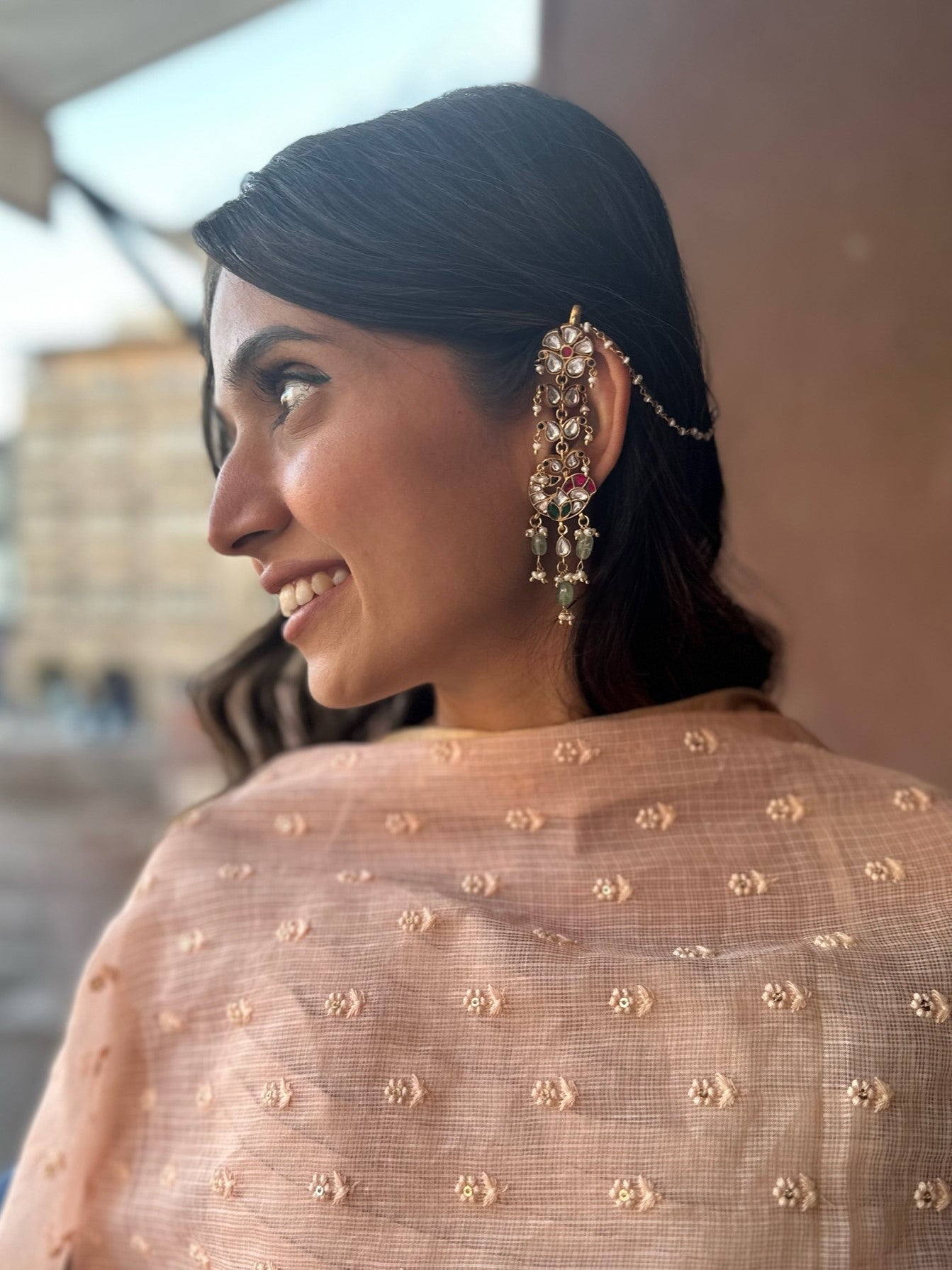 crafted earrings in 92.5 sterling silver with gold polish, featuring a detailed peacock stud and paisley motif kaanchain that mimics delicate peacock feathers.