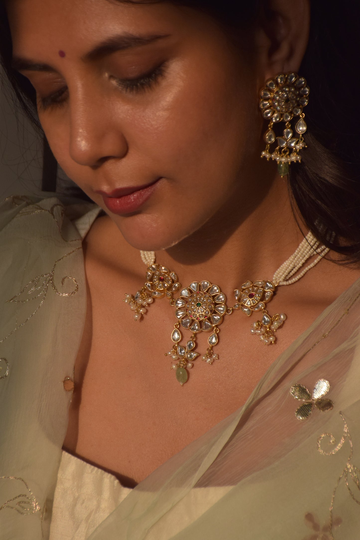 Handcrafted Lata Jadau Choker in 925 silver with gold finish, adorned with detailed Jadau stones and floral motifs, perfect for festive and wedding occasions.