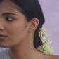  Minimalist long pipe earrings handcrafted in 92.5 sterling silver, featuring a floral motif embellished with white jadau stones. 
