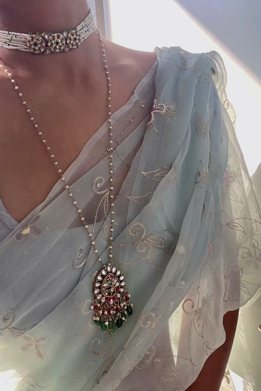 Mayuri pendant in 925 silver with gold polish, featuring a peacock centerpiece adorned with intricate Jadau stones, green strawberry quartz beads, pearls, and pink beads Nuvi Jewels