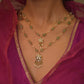 Minimalist two-layered necklace featuring aventurine beads, glass-filled ruby beads, and freshwater pearls with classic Indian pendant motifs.