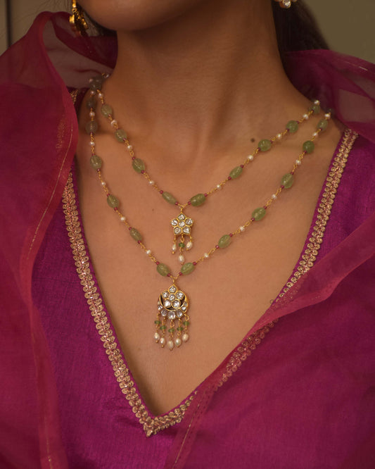 Minimalist two-layered necklace featuring aventurine beads, glass-filled ruby beads, and freshwater pearls with classic Indian pendant motifs.